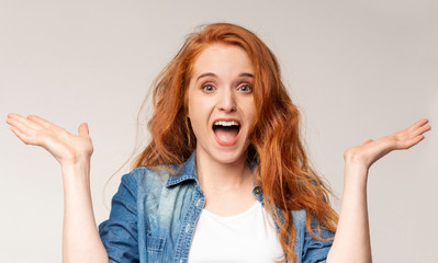 Surprised redhead girl standing with opened mouth