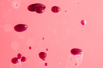 Abstract oil pebbles on pink surface