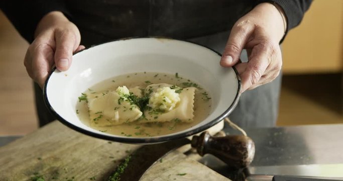 Woman showing cooked home made Maultaschen