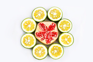 sliced round slices of red natural pomegranate with grains and slices of yellow lime a lemon