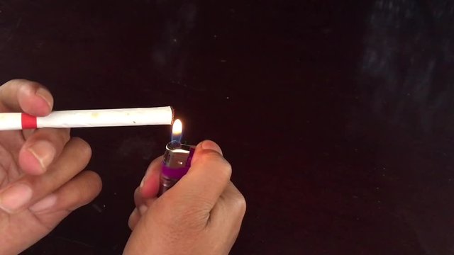 light a cigarette with a gas lighter