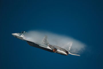 Fototapeta na wymiar Military jet fighter with The Prandtl–Glauert singularity effect 