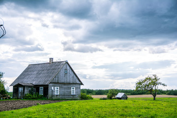 Fototapeta na wymiar Village house in farm, cloudy day summer