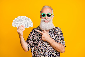 Portrait of white bearded funny old man in eyewear eyeglasses smile win lottery point at hold fan...