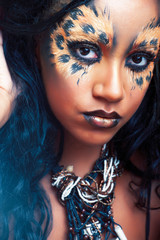 beauty afro girl with cat make up, creative leopard print closeup, fashion style halloween look