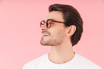 Image in profile of funny caucasian man wearing eyeglasses smiling and looking forward