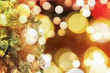 Obraz na płótnie Canvas Winter holiday golden bright shiny bokeh party festive blurry background and Christmas tree on Christmas night.
