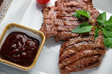 Steak on the bone with red sauce. restaurant menu