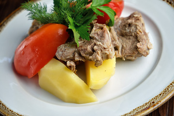 Boiled meat with a side dish and vegetables . restaurant menu