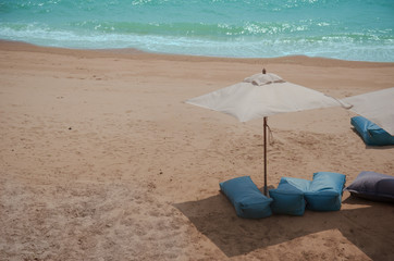Fototapeta na wymiar Mattresses and umbrellas on the beach.