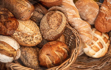 Assortment of Fresh Bread as background, top view.  Rustic loaves of bread close up. .