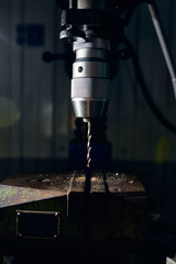 Drilling machine with an inserted drill in the chuck. Close-up.