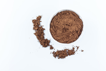tasty cocoa powder in bowl on white background.