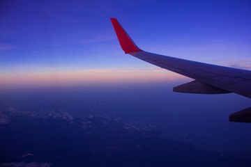 Fototapeta na wymiar Twilight sky view from a window seat of a plane.
