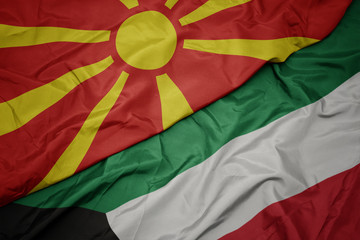 waving colorful flag of kuwait and national flag of macedonia.