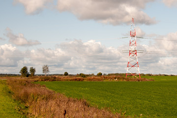 High-voltage electric main against the dark blue sky in summer day