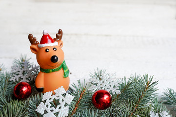 Christmas wooden background with deer and fir tree . View with copy space