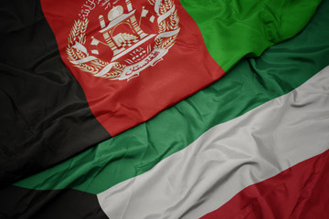 waving colorful flag of kuwait and national flag of afghanistan.