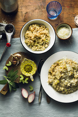 Classic Italian risotto with mushrooms on a wooden table with a blue linen tablecloth. red wine. bottle and glasses. top shots