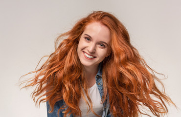 Closeup portrait of beautiful redhead girl smiling