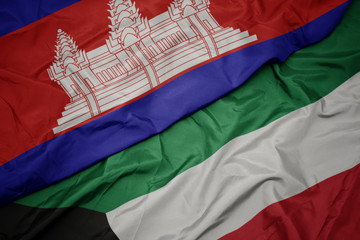 waving colorful flag of kuwait and national flag of cambodia.