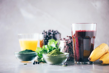 Healthy eating, alkaline diet, vegan concept. Blueberries, bilberry, barley grass juice, spirulina,...