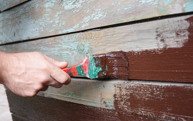 Contractor Repainting Wooden Old Wall.