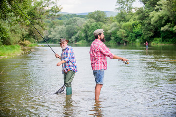 Summer weekend. Fisherman family. Hobby sport activity. Father and son fishing. Fisherman fishing equipment. Fisherman grandpa and mature man friends. Peaceful activity. Nice catch. Rod and tackle