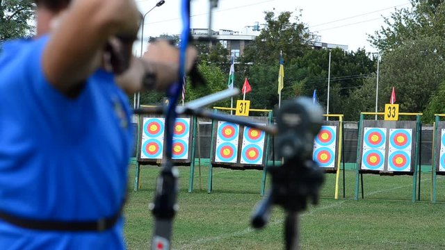 Archers aim and shoot at targets.