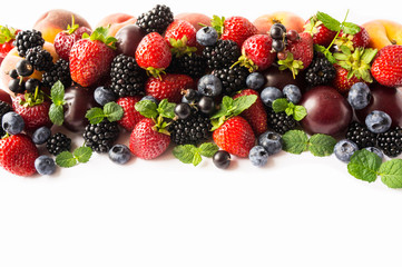 Fototapeta na wymiar Ripe blackberries, strawberries, bleberries, blackcurrants and plums. Top view. Background berries and fruits. Various fresh summer fruits. Background of mix berries and fruits. 