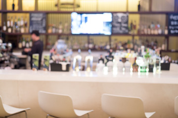 Blurred of pub bar counter with various spirits and beer
