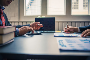 Business people are reporting business results from graph paper.Business Analysis and Strategy