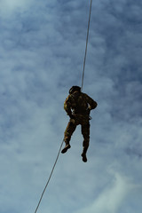Special Forces descends the rope at a military airfield