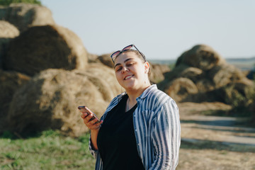 portrait of a beautiful girl on a background of haystacks 1