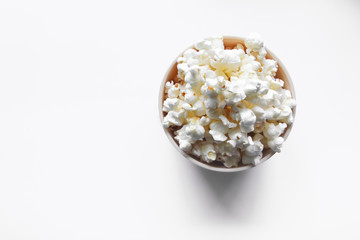 Popcorn in a bowl on white background.