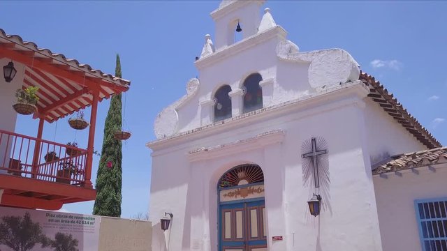 Slow sliding 4k opening shot of church and blue sky in summer, Pueblito Paisa