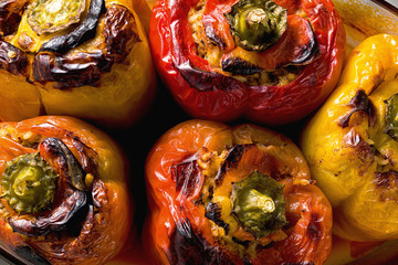 freshly baked stuffed peppers with lentils and rice, in a glass baking dish. festive vegan food