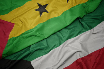 waving colorful flag of kuwait and national flag of sao tome and principe .