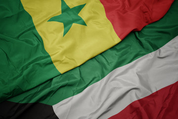 waving colorful flag of kuwait and national flag of senegal.