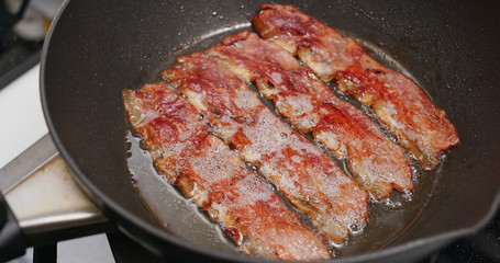 Cooking crispy bacon in the kitchen