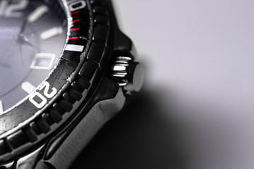 Diver watch case part closeup on white background.