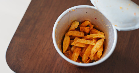 Eating potato chips from a paper cup