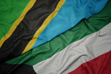 waving colorful flag of kuwait and national flag of tanzania.