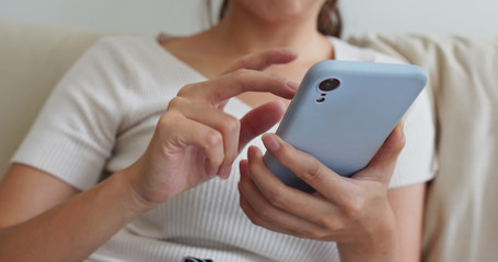 Woman use of mobile phone at home