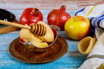 Orthodox Jewish holiday honey on the pomegranate and apples. Jewish new year Rosh Ha Shana shofar