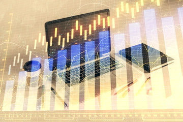 Forex graph hologram with desktop office computer background. Double exposure. Concept of financial...