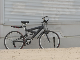 old mountain bike standing on the beach