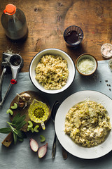 Classic Italian risotto with mushrooms on a wooden table with a blue linen tablecloth. red wine. bottle and glasses. top shots
