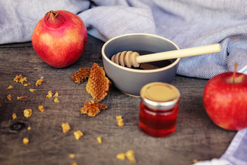 Jewish National Holiday. Rosh Hashana with honey, apple and pomegranate on wooden table.