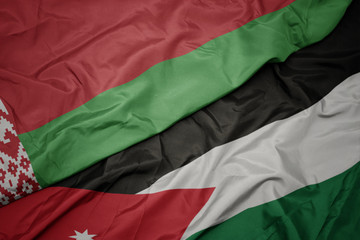 waving colorful flag of jordan and national flag of belarus.